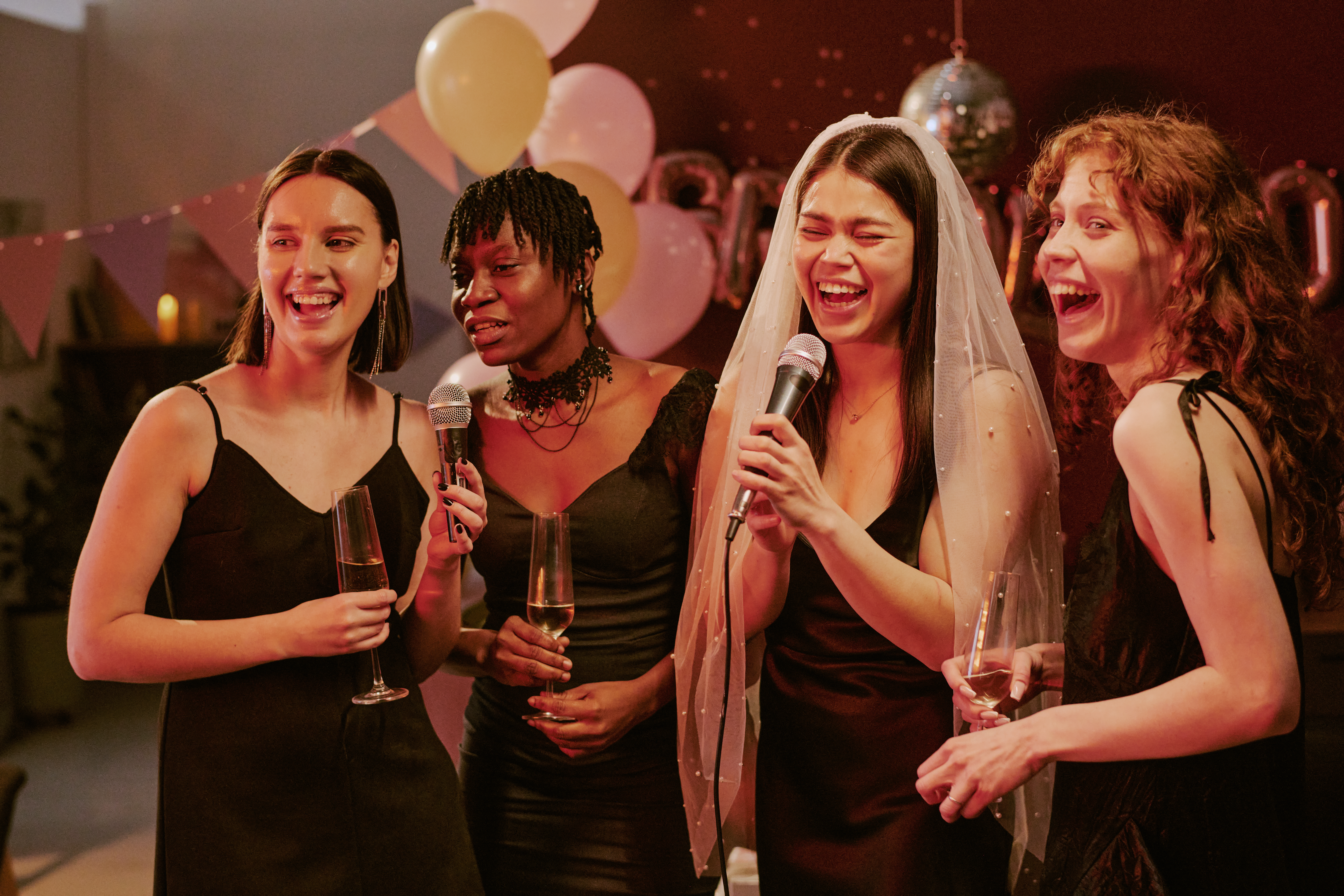 Group of Young Adult Multiethnic Women Singing Karaoke during Bachelorette Party Graduaciones Elite: El Broche de Oro a tu Esfuerzo